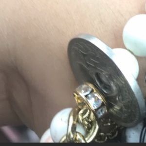 One white beaded bracelet with French Coin.